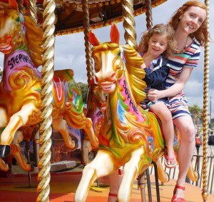 Holiday carousel horse fairground ride